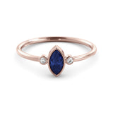 A delicate marquise sapphire ring and a pair of diamonds