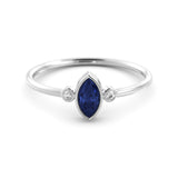 A delicate marquise sapphire ring and a pair of diamonds