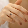 A delicate marquise sapphire ring and a pair of diamonds