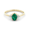 A delicate emerald and diamond ring