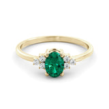 A delicate emerald and diamond ring