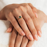 A delicate emerald and diamond ring