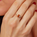 A fine orange sapphire and diamond ring